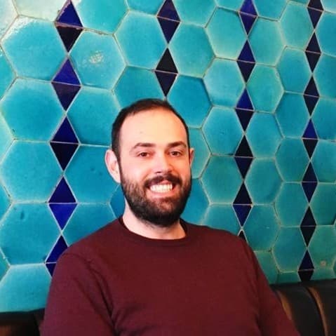 Nathan in the kitchen arranging bottles